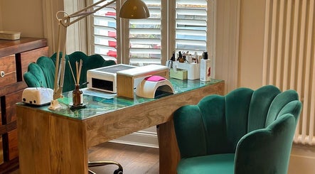 Elegant nail salon desk at Chapter1 Salon, Cheltenham, England, GB with plush chairs and nail equipment.