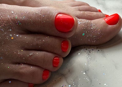 Bright red pedicure with glitter at Chapter1 Salon, Cheltenham, England, GB.
