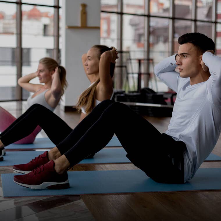 Fitness trainer guiding a client through a workout in a gym, depicting fitness services available on Fresha.