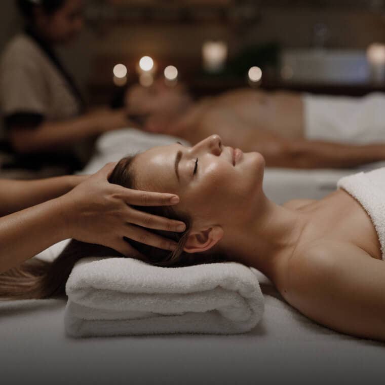 Woman relaxing in a spa with a towel wrap and facial mask, representing spa and wellness services on Fresha.