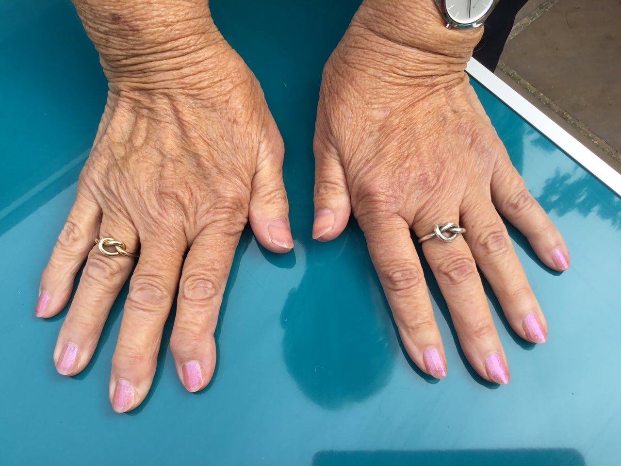 Gel nail art with pink polish and knot rings at Vanilla Hair & Beauty in Trowbridge, England, GB